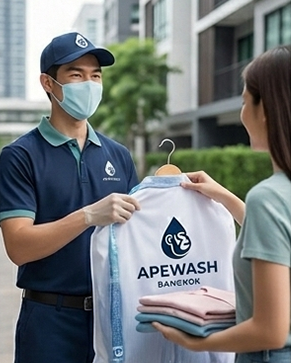 Apewash delivery staff holding clean folded laundry in Bangkok